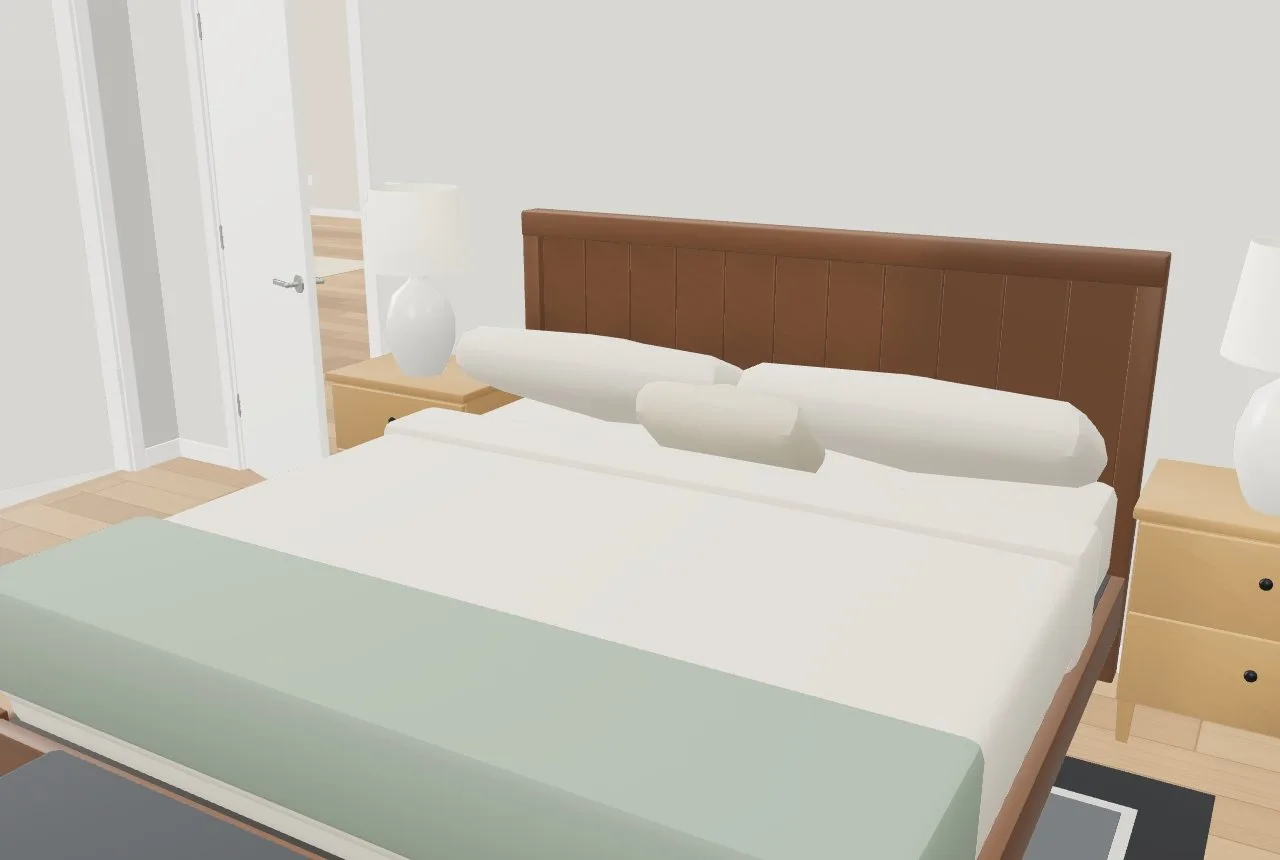 The primary bedroom at eye height: a king bed made up with sheets, duvet, pillows and a throw, nightstands and lamps