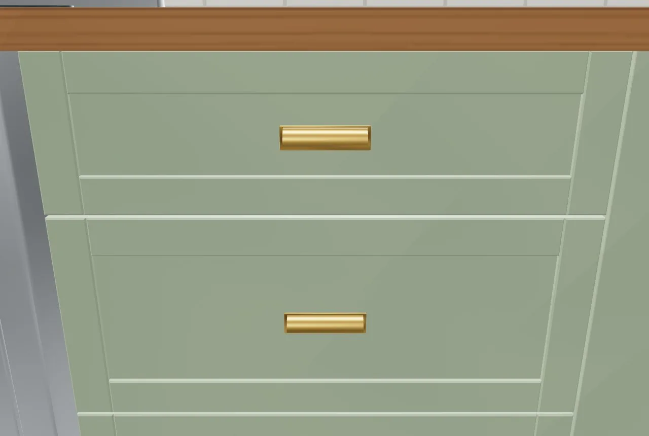 Beadboard drawer fronts in sage with brushed brass cup pulls, close up